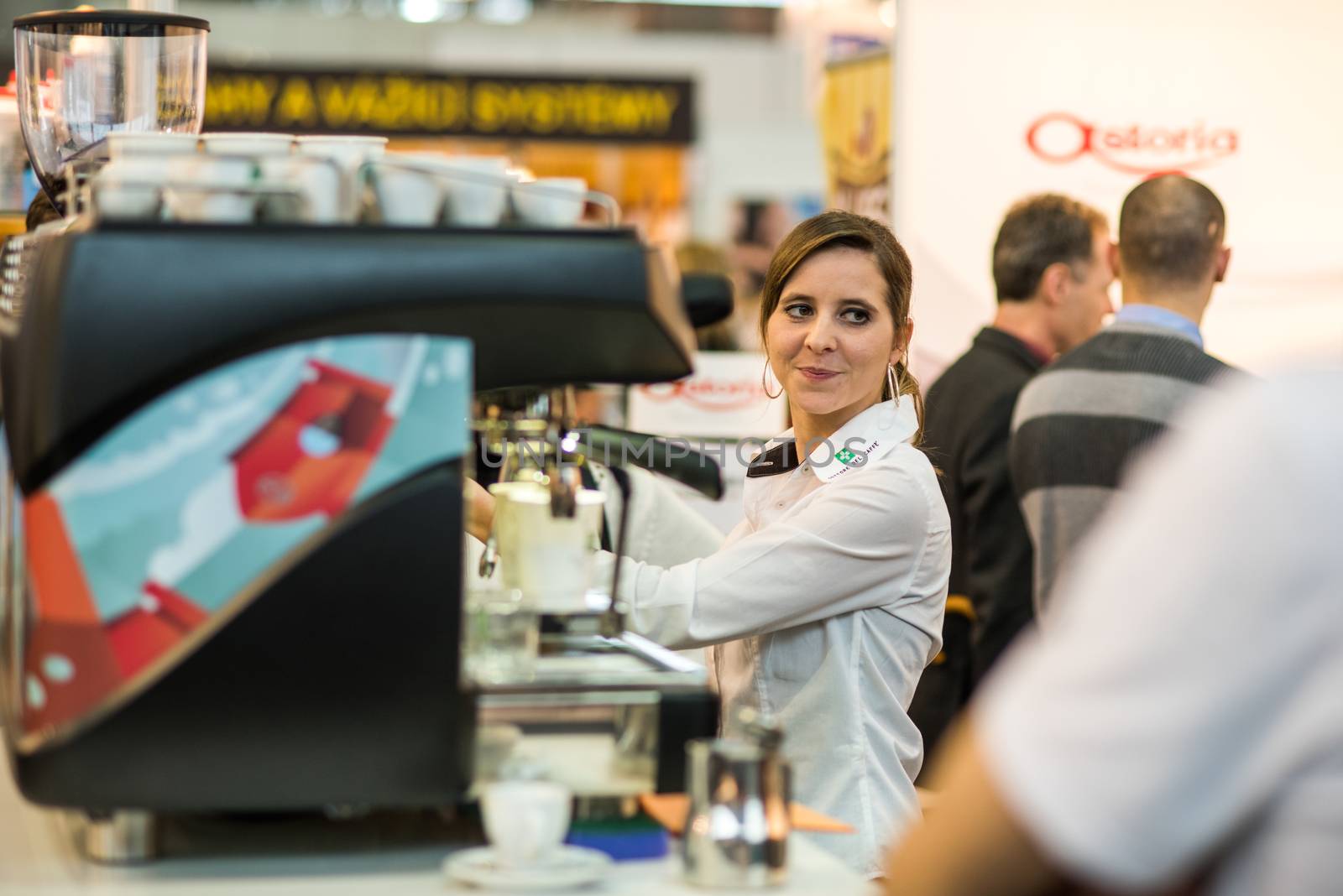 Woman in charge of preparing is preparing coffee to the guest attending an event at the convention trade center in Brno. BVV Brno Exhibition center. Czech Republic