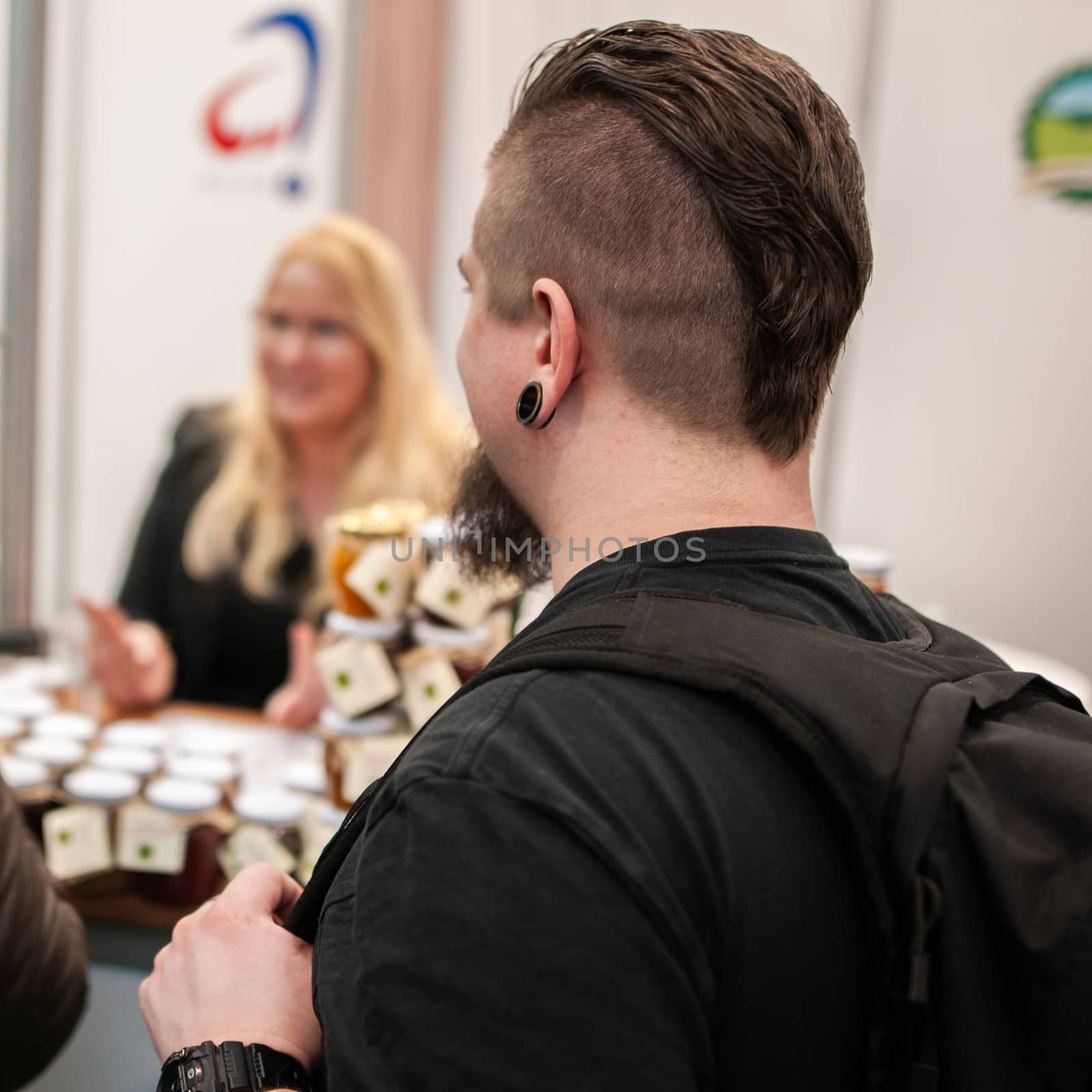 03/04/2018. Brno, Czech Republic. Young men having a conversation while attending an event at the convention trade center in Brno. BVV Brno Exhibition center. Czech Republic by gonzalobell