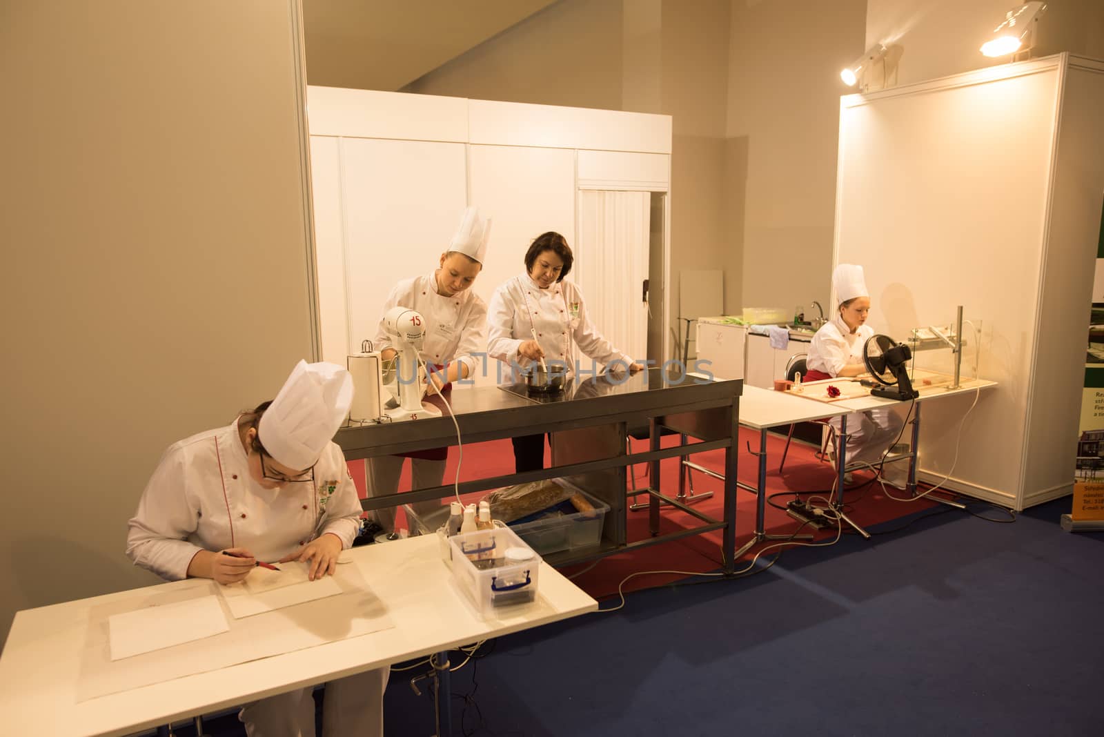 Four women are preparing food while attending an event at the convention trade center in Brno. BVV Brno Exhibition center. Czech Republic