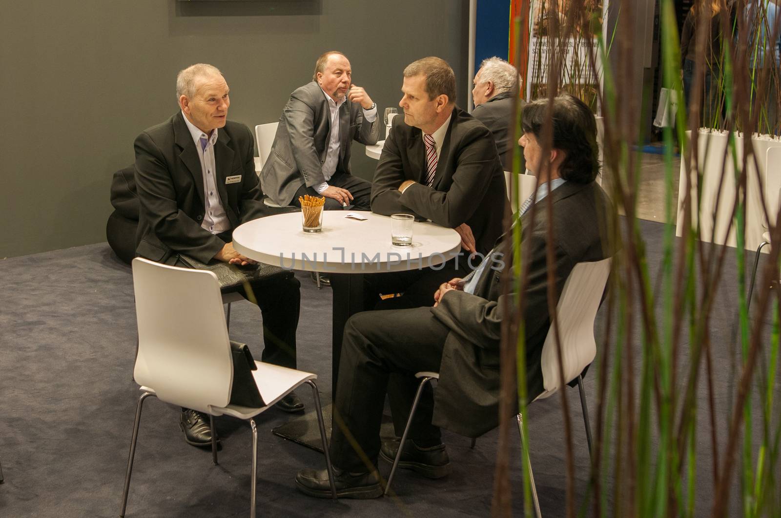 Business men having a meeting while attending an event at the convention trade center in Brno. BVV Brno Exhibition center. Czech Republic