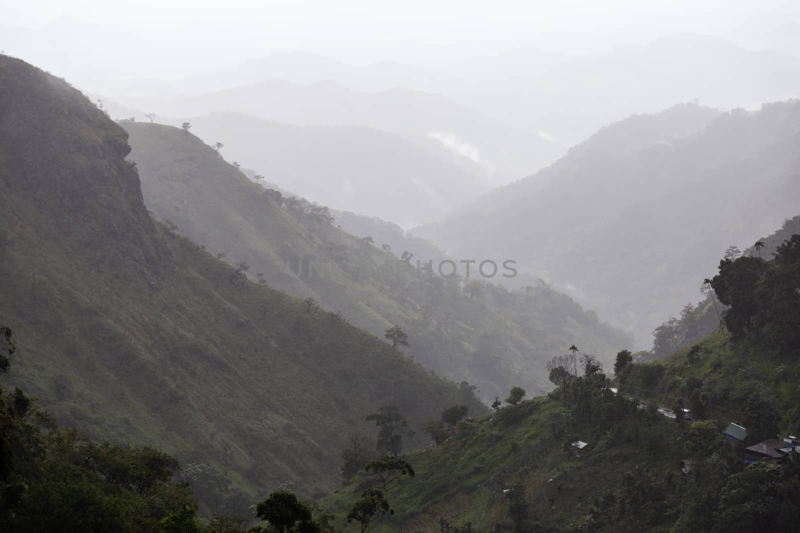 Ella Sri Lanka mountain gap landscape views across the wide valley to mountains in the distance misty early morning Adams Peak. High quality photo