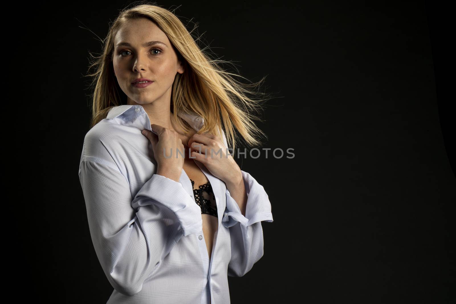 A gorgeous blonde model posing in a studio environment