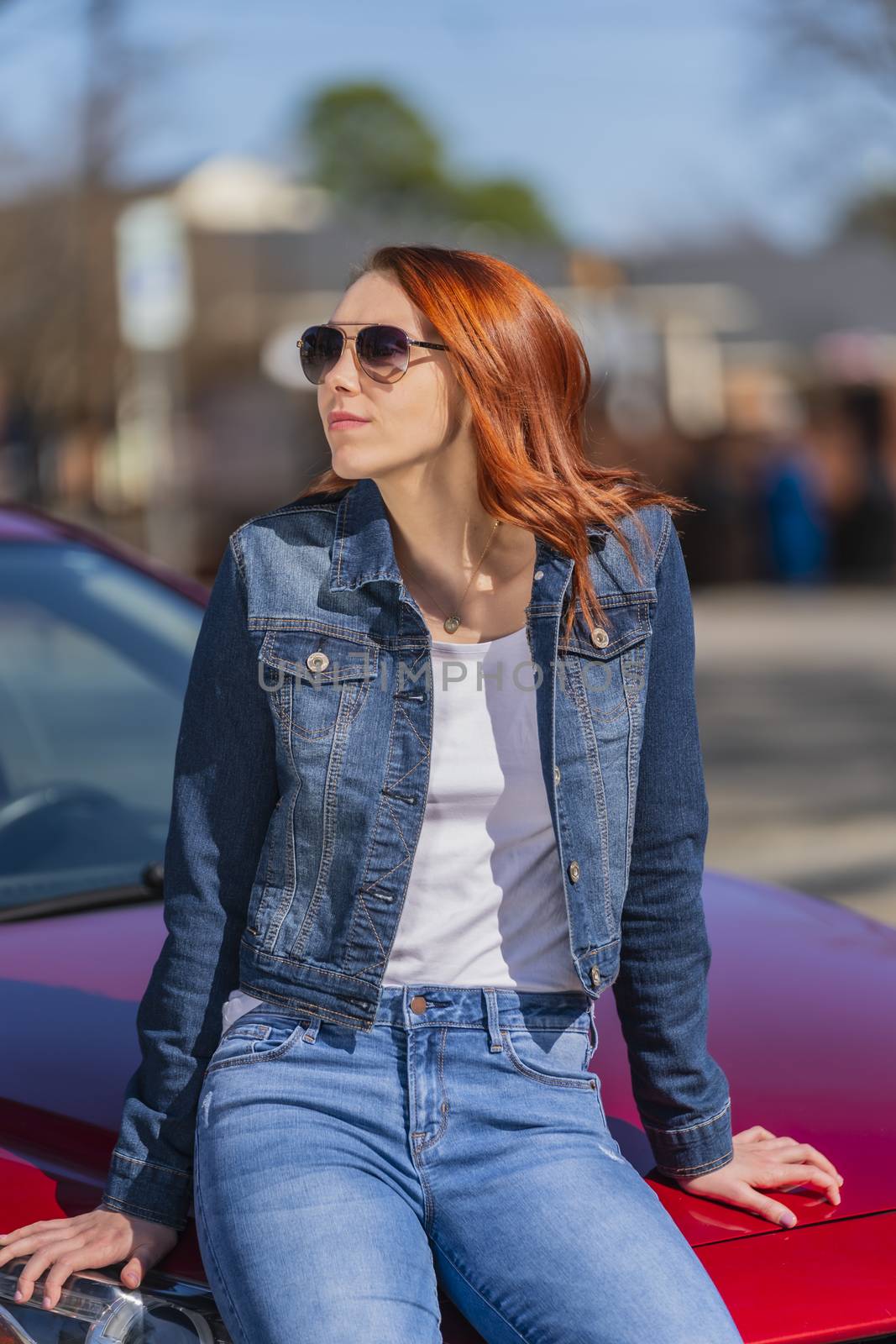 A gorgeous redhead model enjoys a spring day outdoors