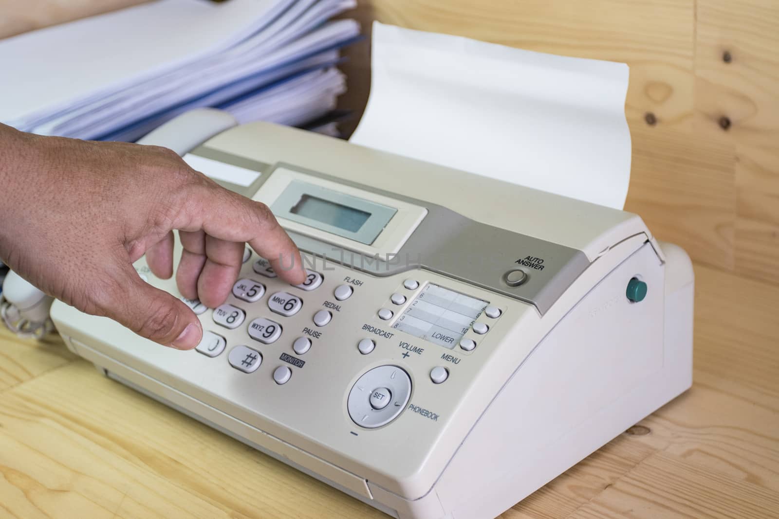 hand man are using a fax machine in the office, equipment for data transmission.