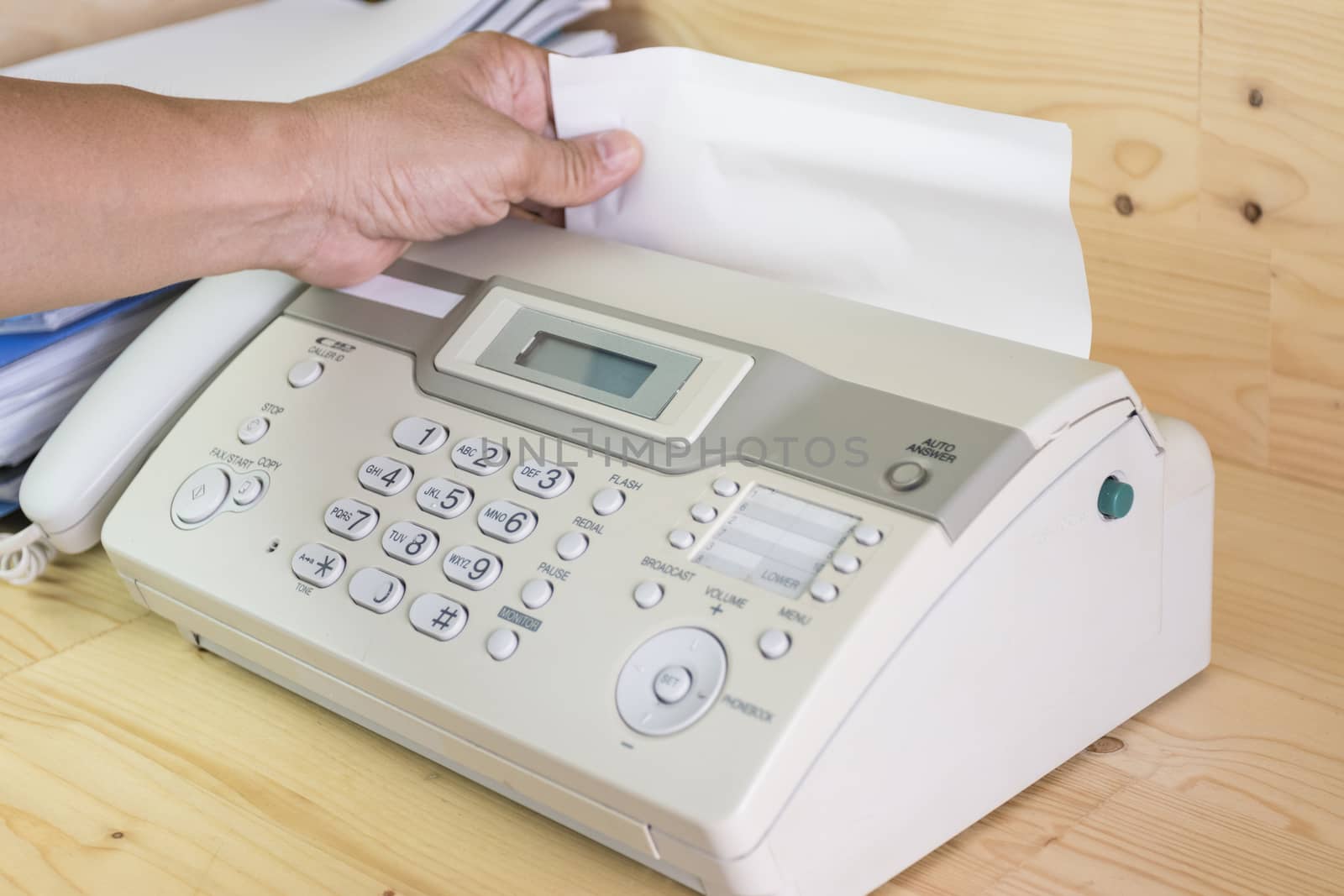 hand man are using a fax machine in the office, equipment for data transmission.