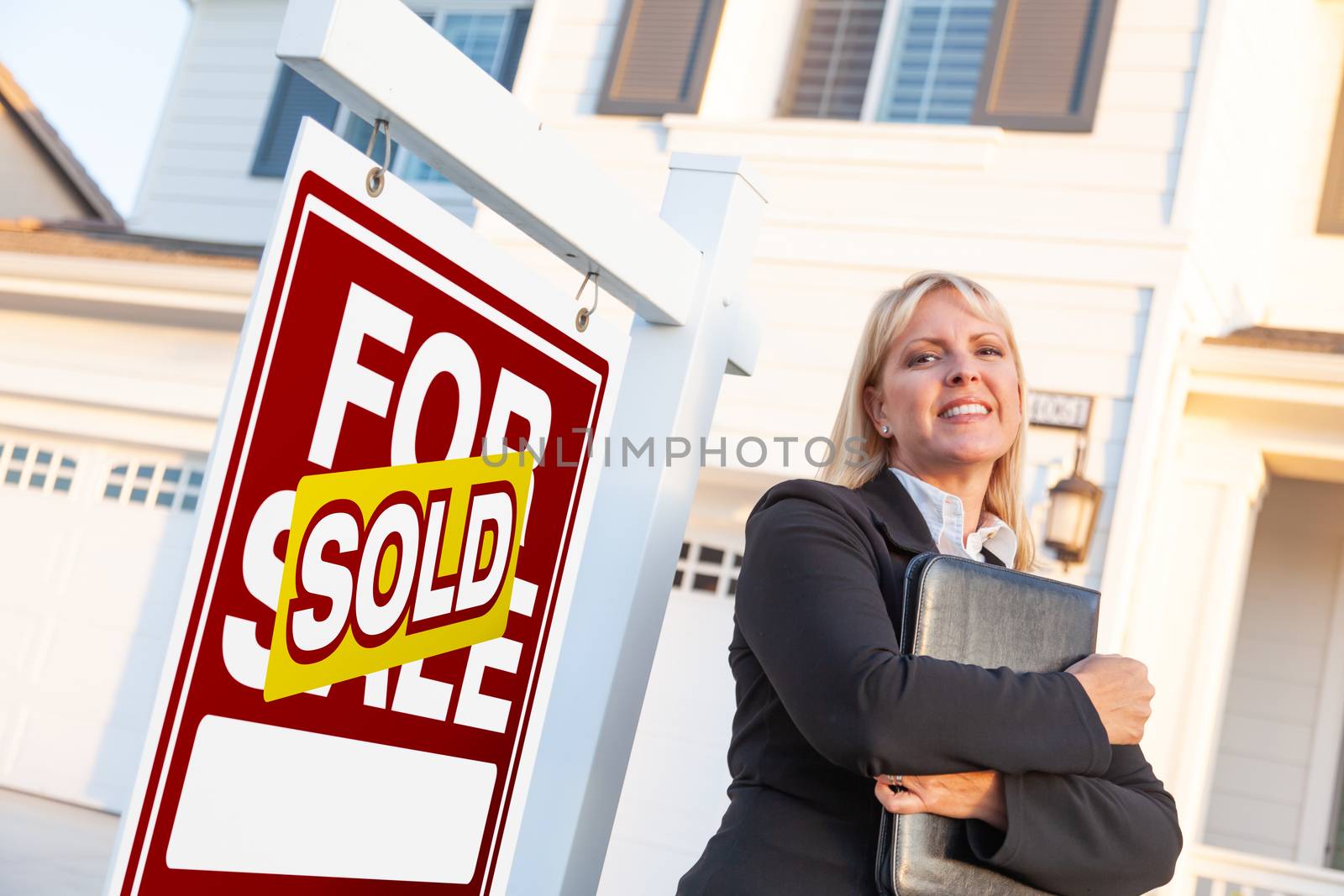 Female Real Estate Agent in Front of Sold For Sale Sign and Beau by Feverpitched