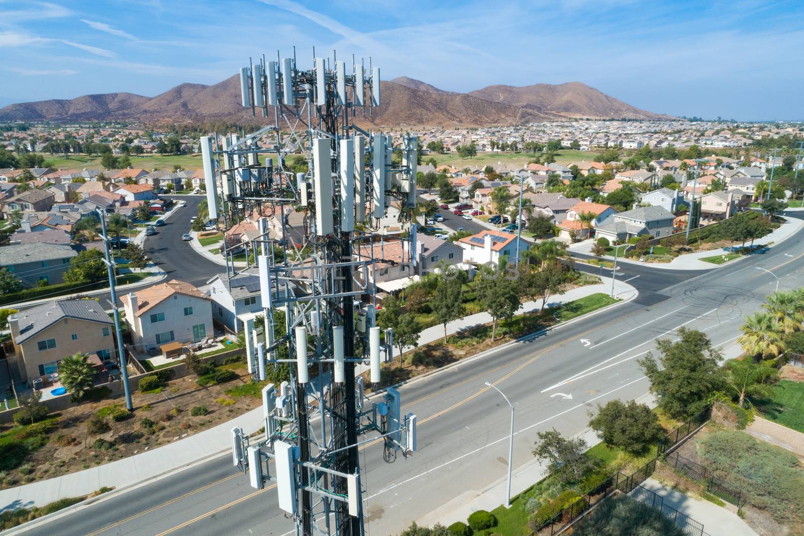 Close-up Aerial of Cellular Wireless Mobile Data Tower with Neig by Feverpitched