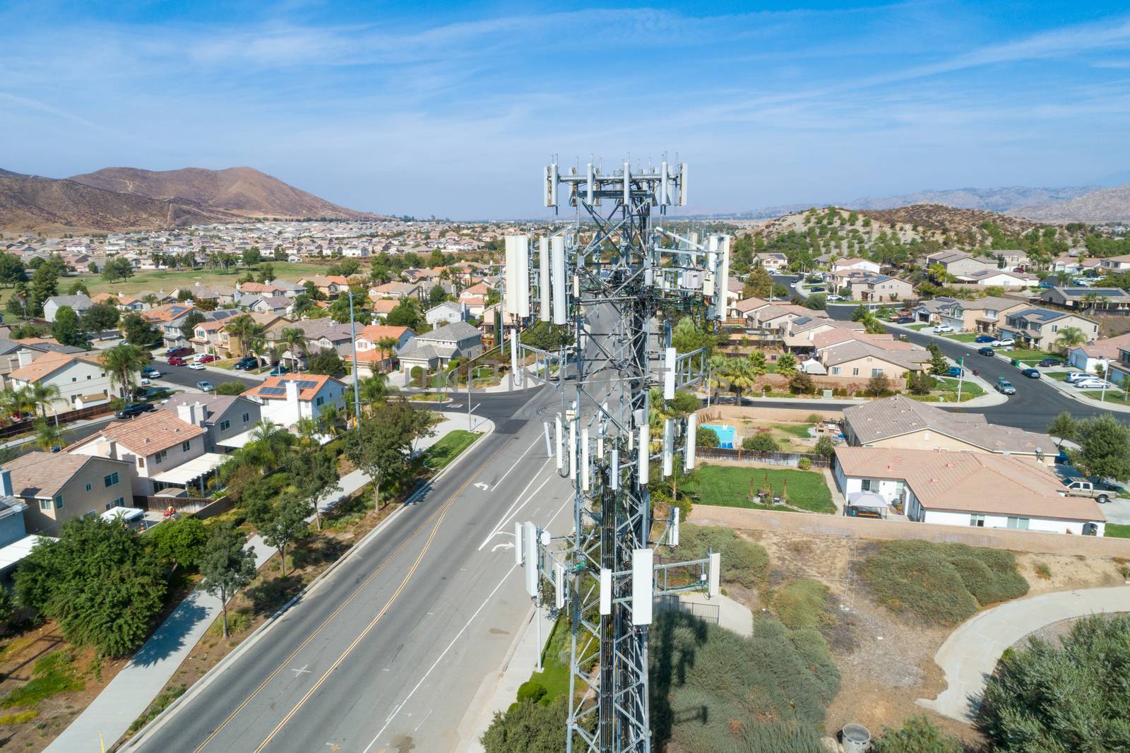 Close-up Aerial of Cellular Wireless Mobile Data Tower with Neig by Feverpitched