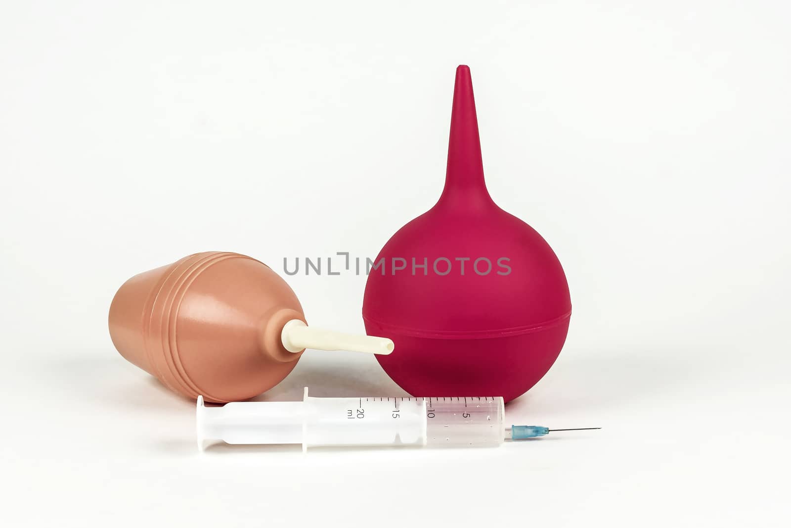 Two medical syringes and a medical syringe with a needle