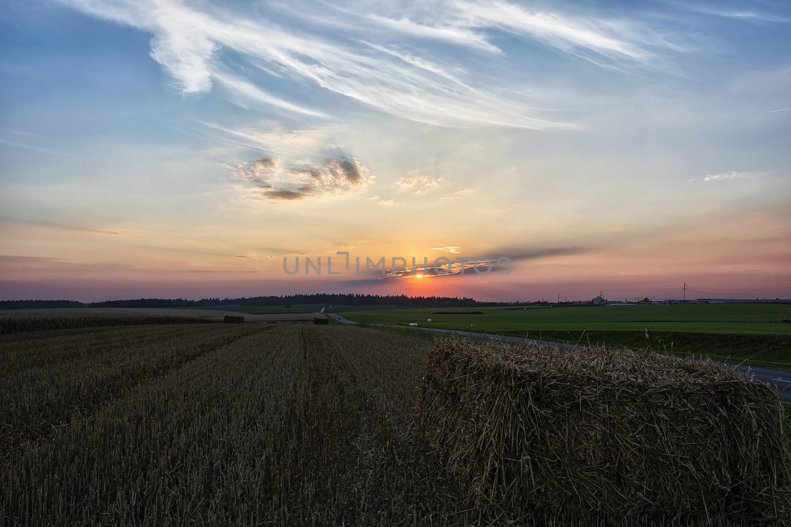Evening sunset in the field after harvesting