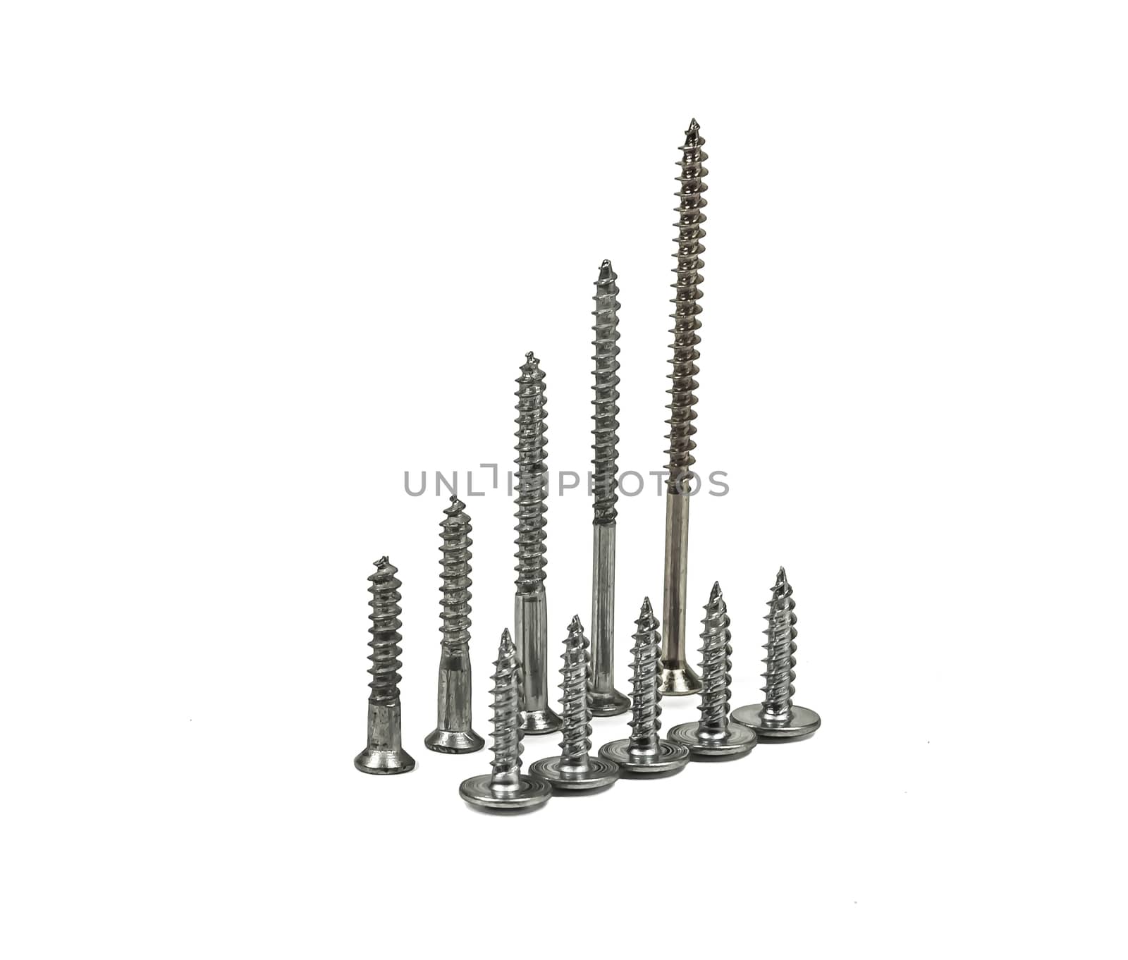 On a light background stand on the screws of screws of different sizes