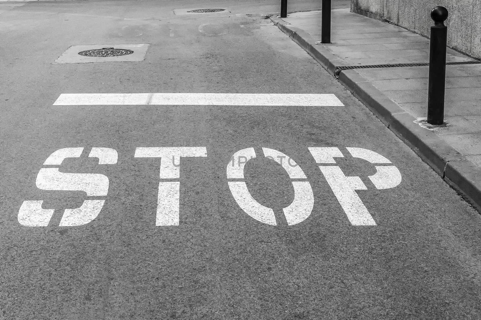 On the asphalt roadway marked the road marking "STOP"