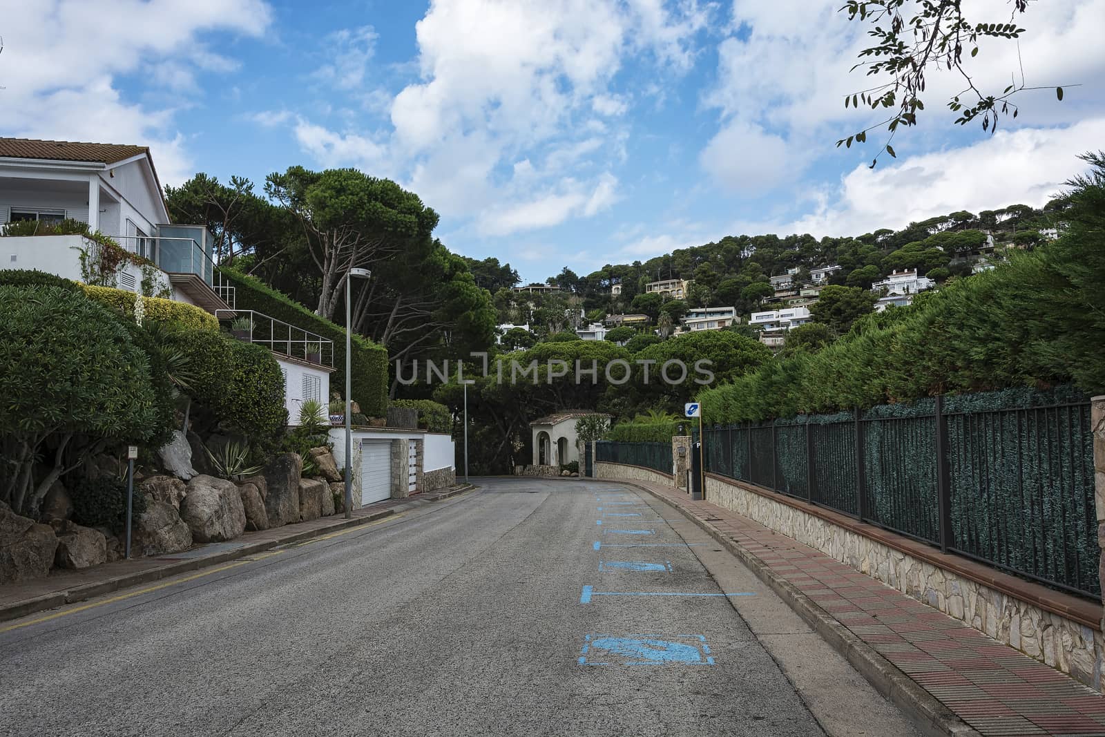 On the roadway of the city street there is a marking "Paid parking" (Blanes, Spain)