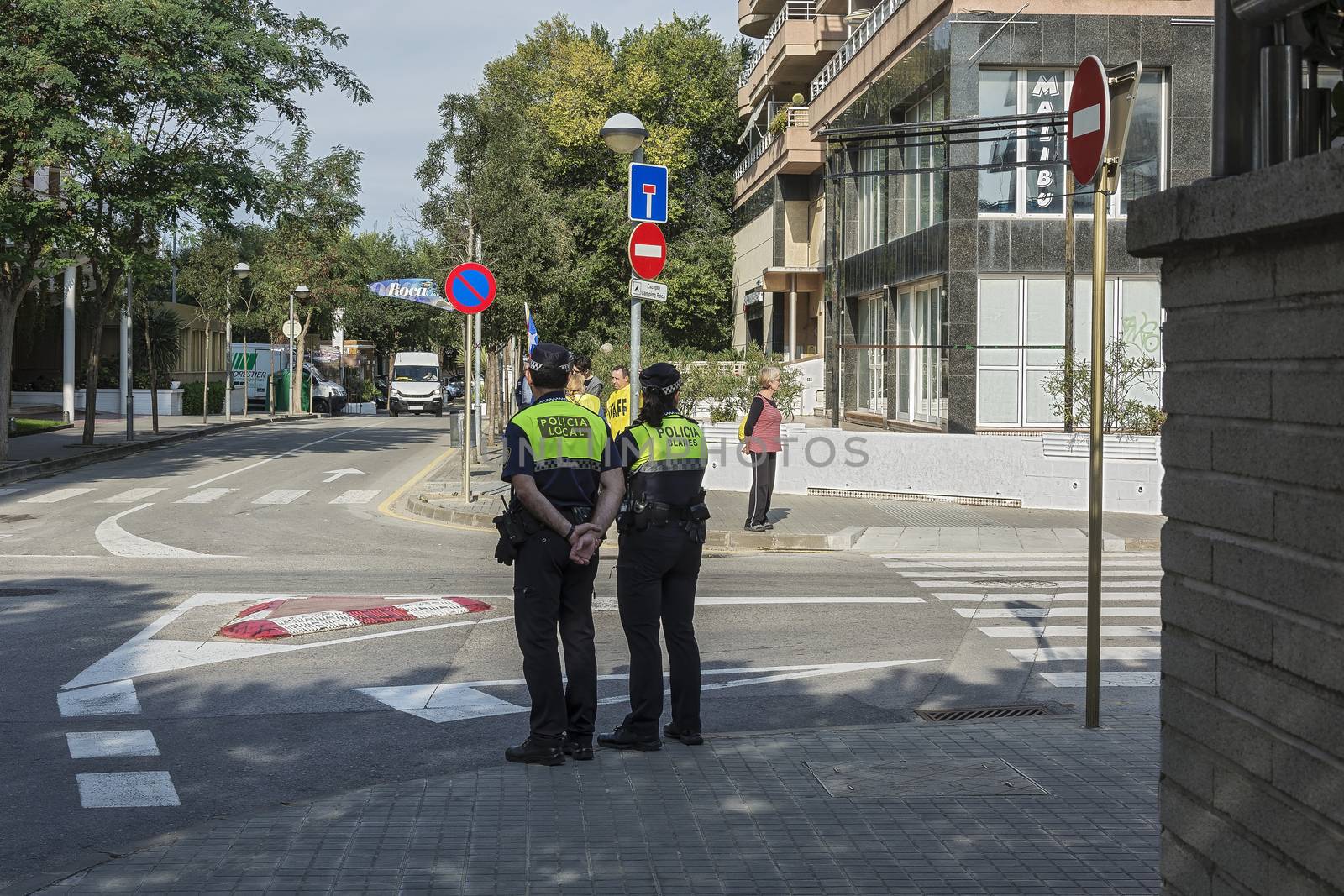 Spain, Blanes - 09/23/2017: Two policemen stand at the crossroads of the city street