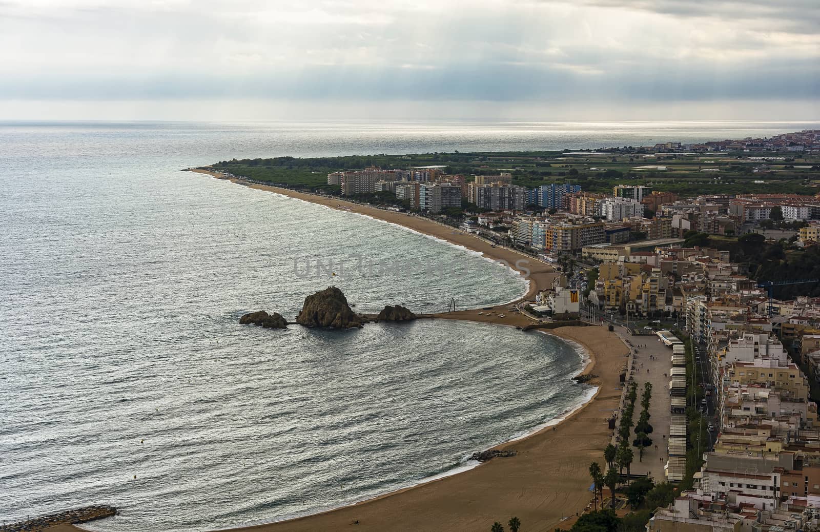 Embankment and sand beach of Blanes in cloudy weather (Spain)
