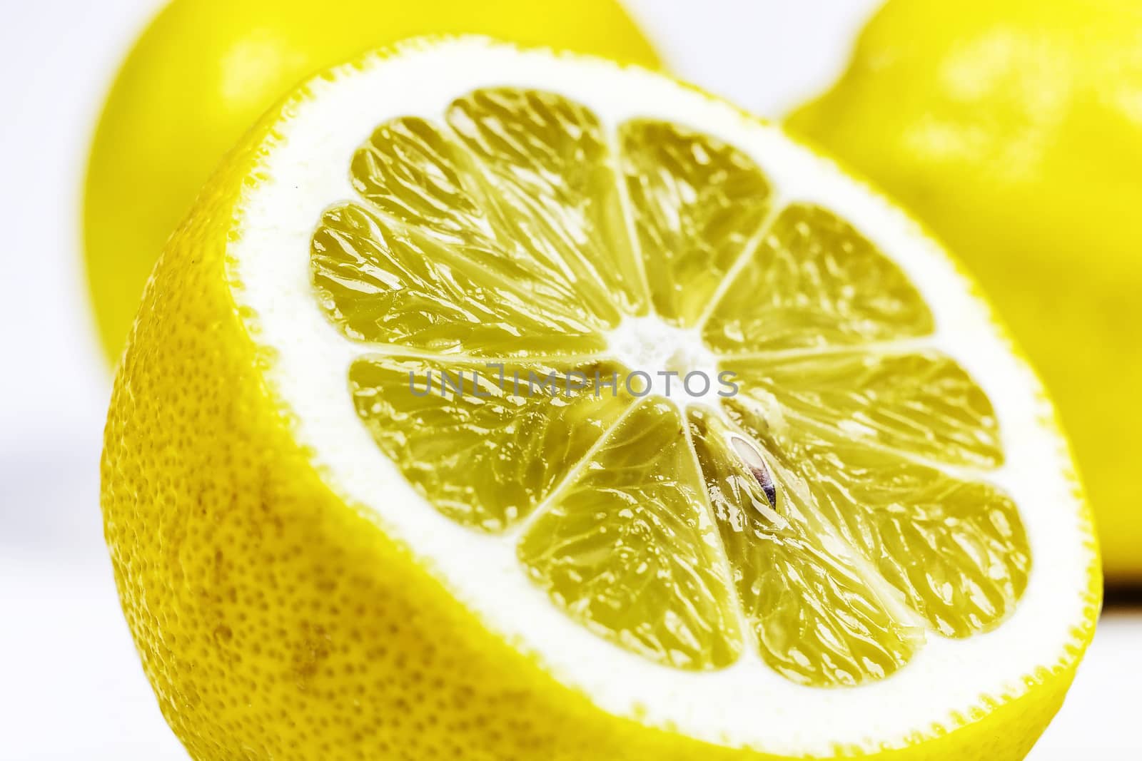 On a white background a cut half of a lemon close-up