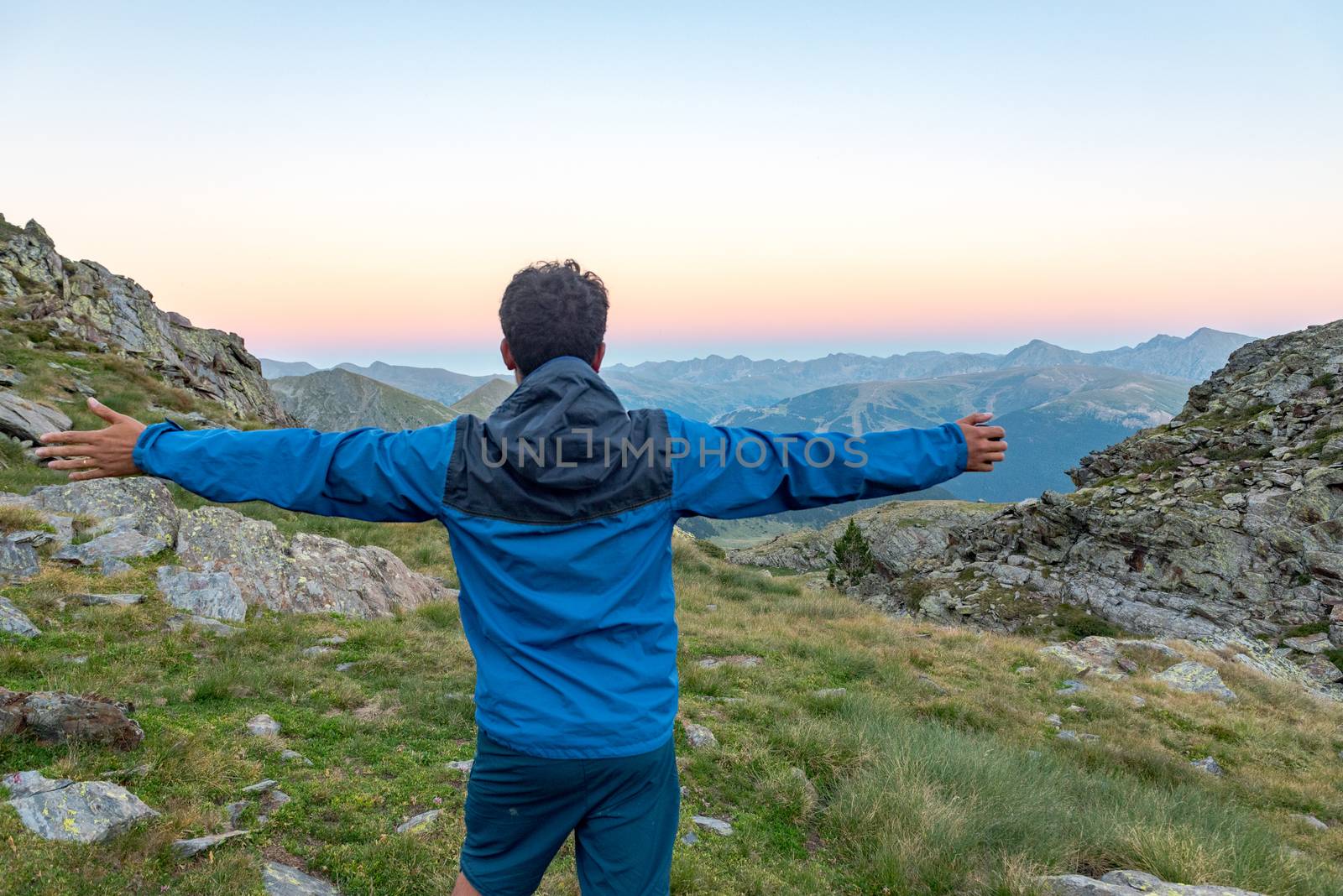 Men in the Vall de Riu lake from the Estanyo peak in Andorra in summer 2020.
