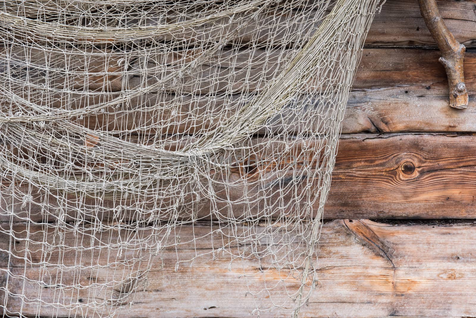 Fishing old network on wooden wall, fishing net texture of fisherman folk, woven with nylon rope.