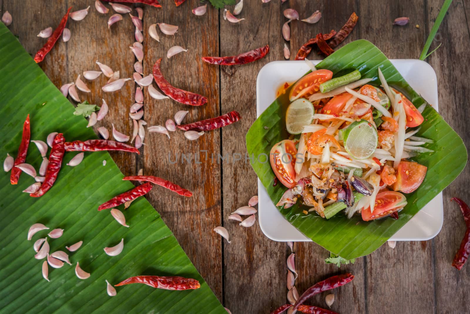 Papaya Salad or Som Tam in a plate with ingredient