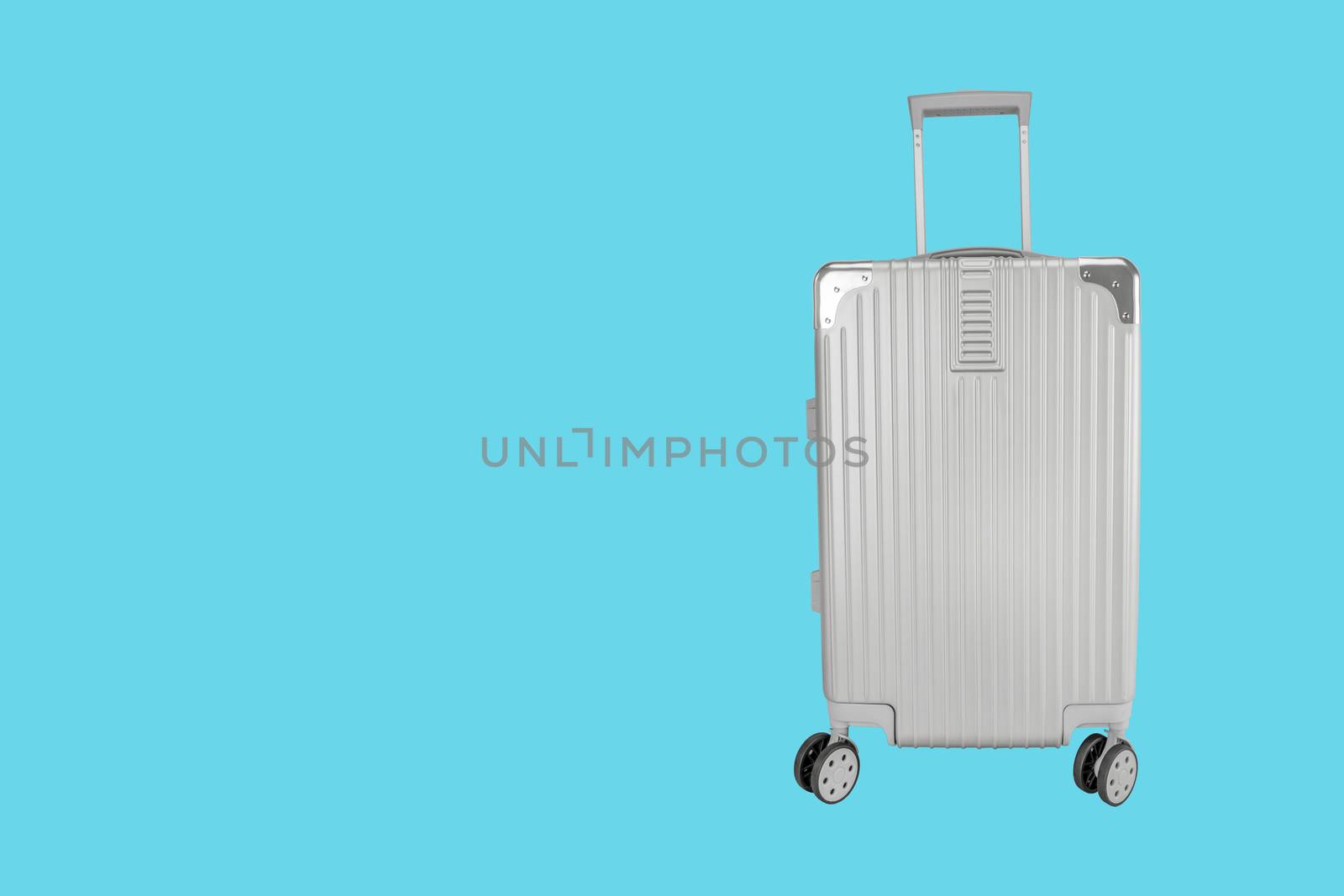 Silver luggage bag with copy space on blue background by Buttus_casso