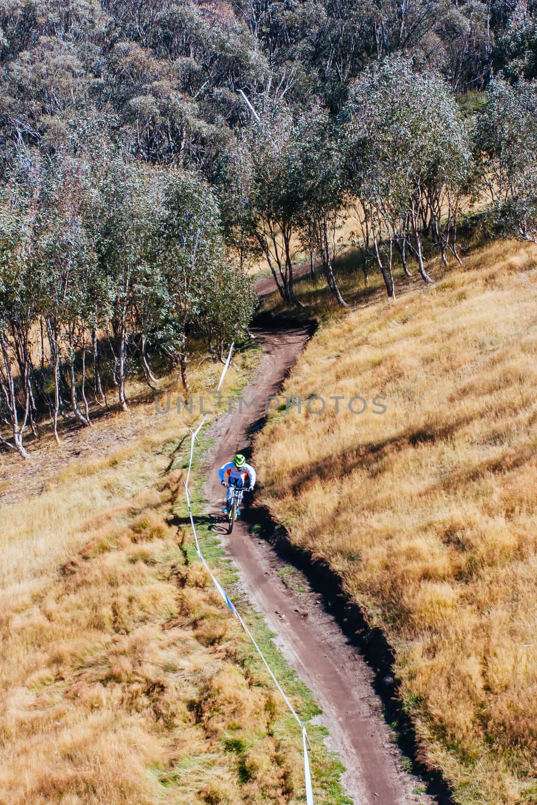 Mountain bikers descend down Thredbo on a cool autumn day in the Snowy Mountains, New South Wales, Australia