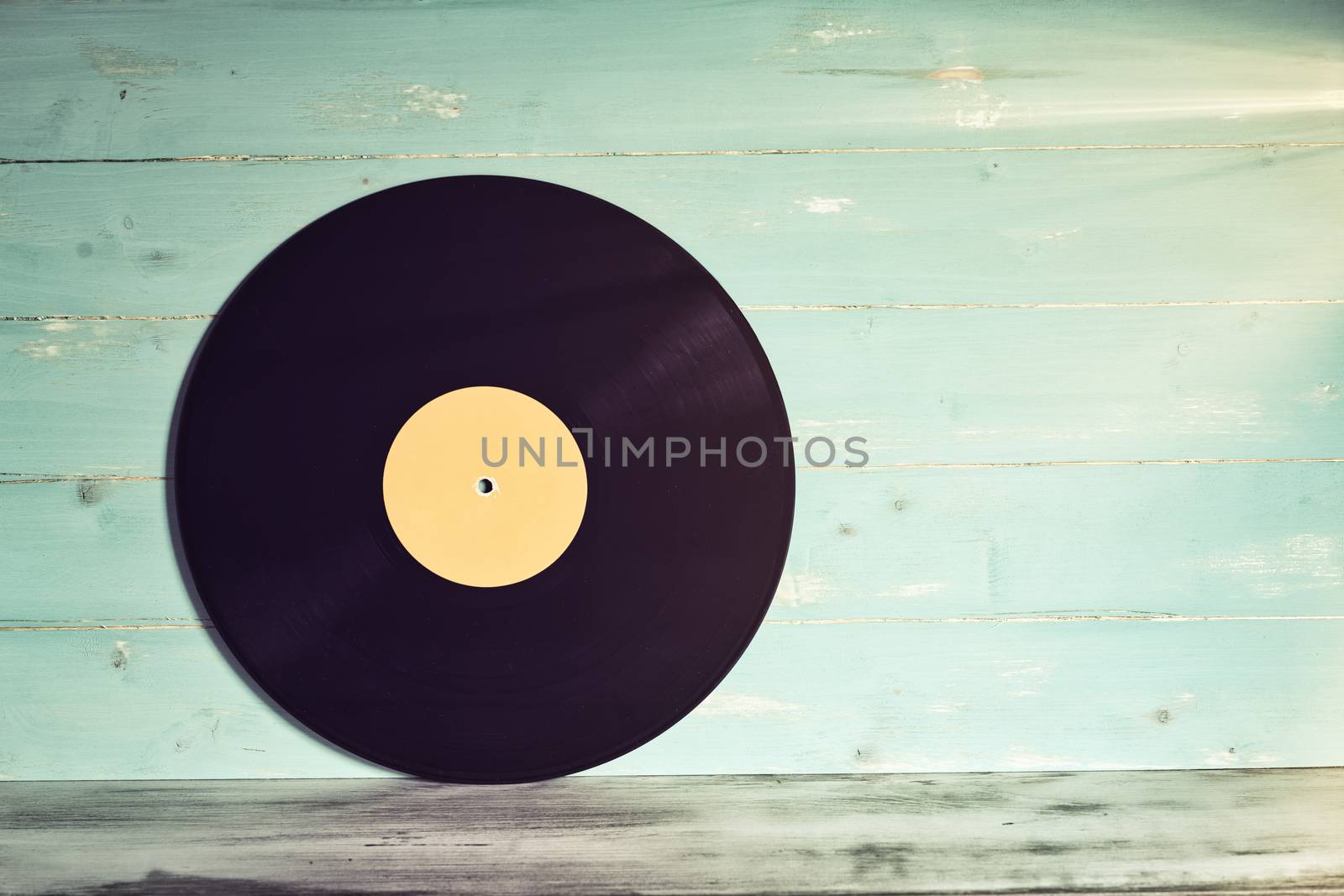 Vinyl record on wooden background,Old vintage vinyl record isolated