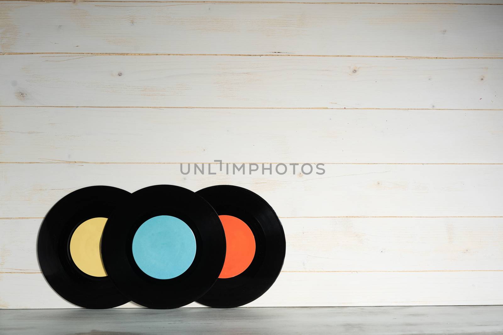 Three Vinyl records on wooden background,Old vintage vinyl records isolated