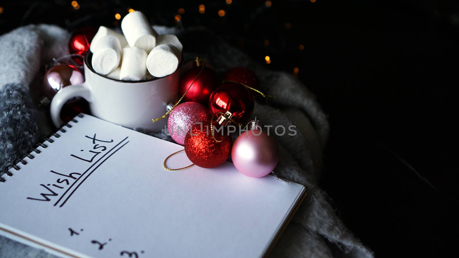 Christmas background with wish list, coffee mug with marshmallow and Christmas balls