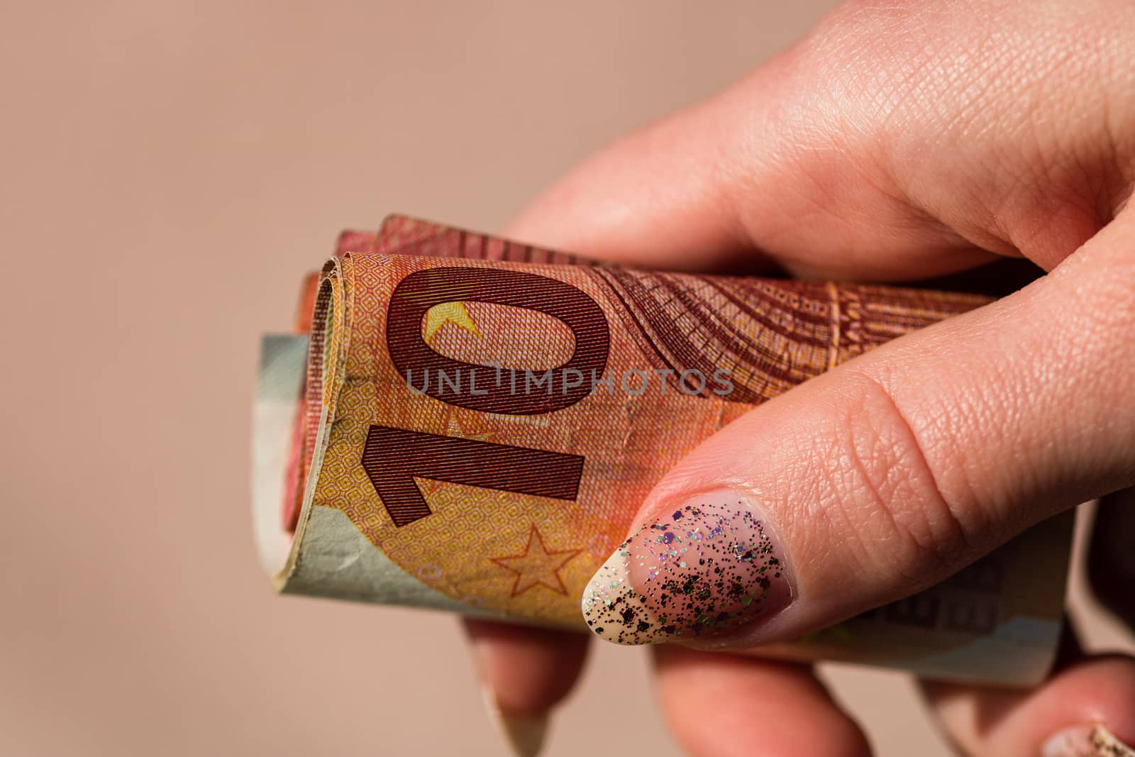 Man hands giving money like a bribe or tips. Holding EURO banknotes on a blurred background, EU currency