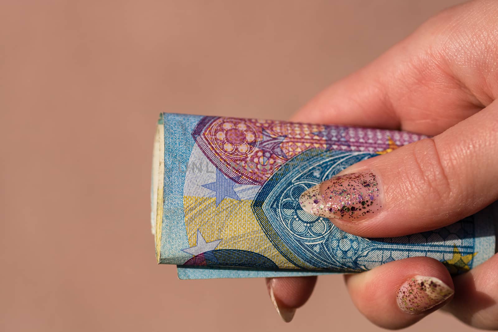 woman hands giving money like a bribe or tips. Holding EURO banknotes on a blurred background, EU currency