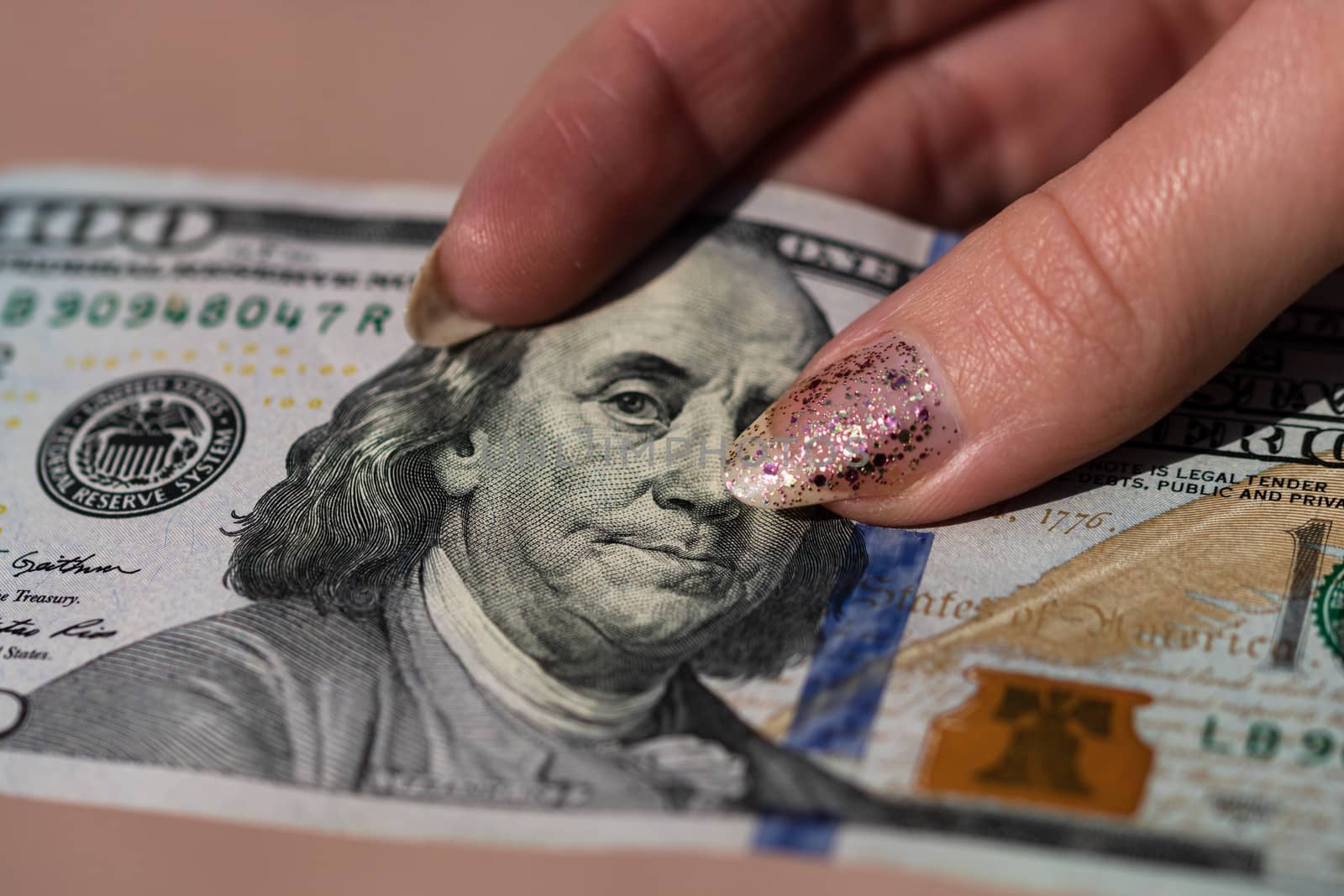 Hands giving money like a bribe or tips. Holding US dollars banknotes on a blurred background, US currency