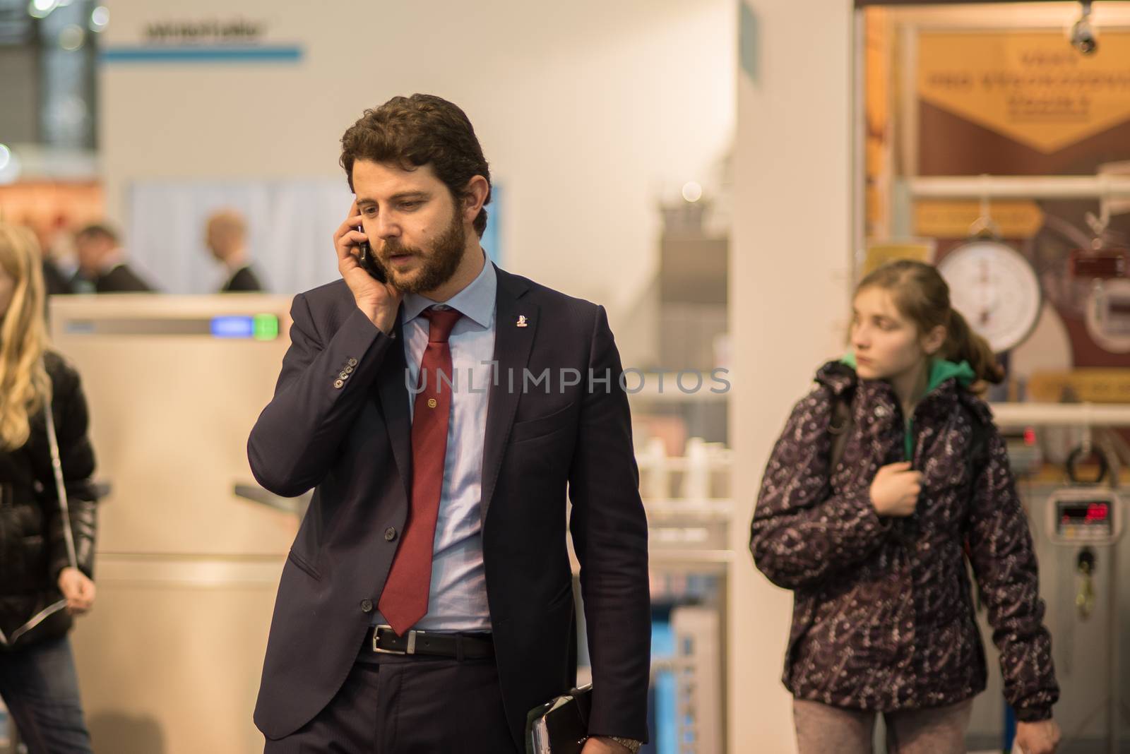 03/04/2017. Brno, Czech Republic. Man speaking on his phone while walking at the convention trade center in Brno. BVV Brno Exhibition center. Czech Republic by gonzalobell