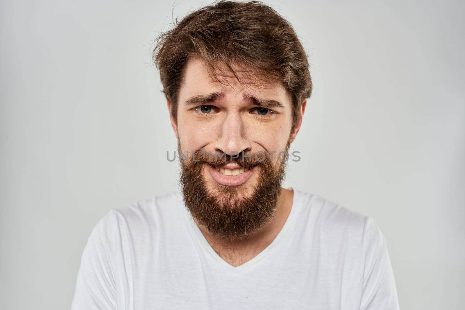 emotional bearded man close-up facial expression studio lifestyle. High quality photo