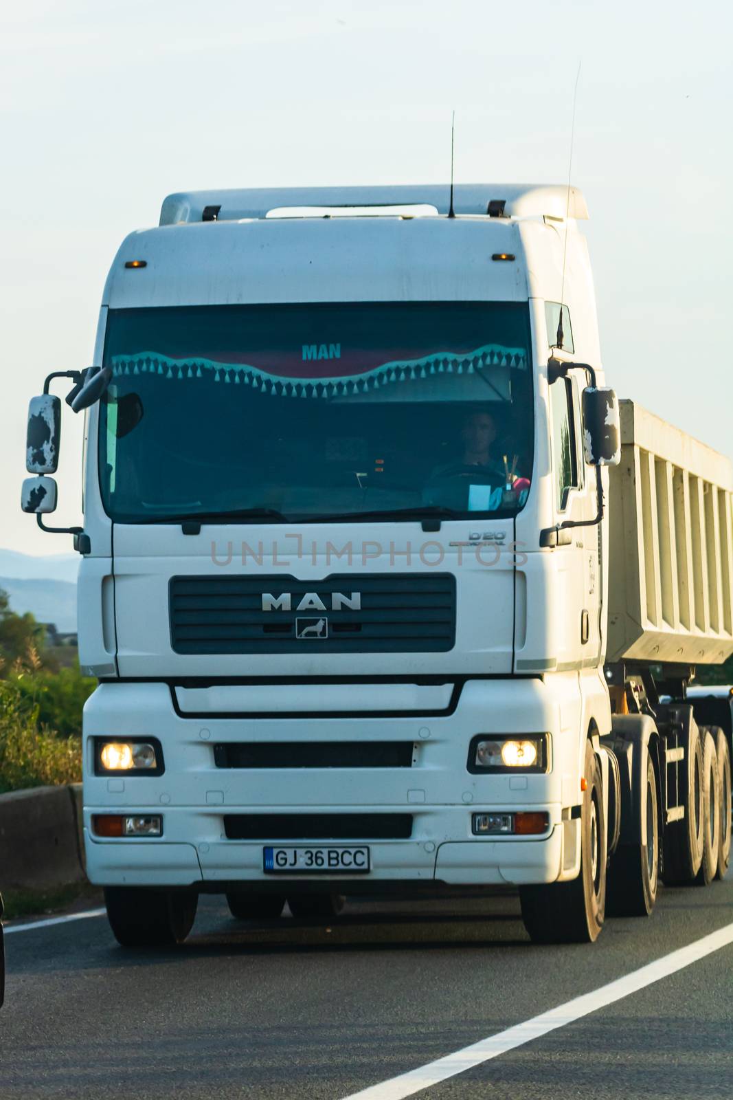 Loaded European truck in motion on asphalt road, transportation and delivery concept. Bucharest, Romania, 2020