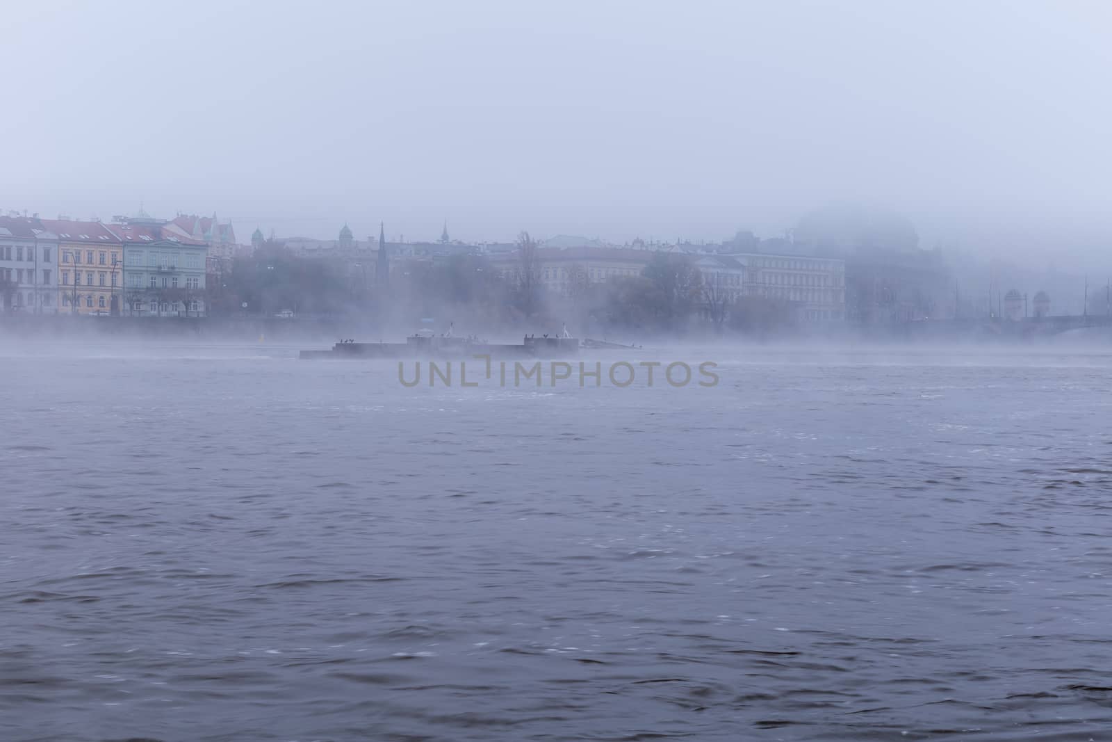 Autumn dawn in historic Prague at Charles Bridge over the Vltava River. Prague, ENESCO monument, Czech Republic