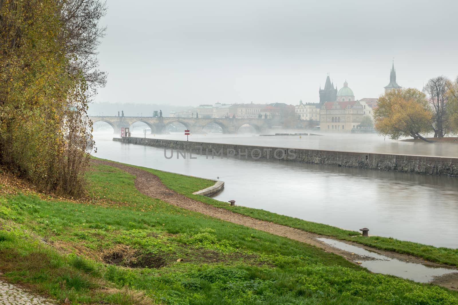 Autumn dawn in historic Prague at Charles Bridge over the Vltava River. Prague, ENESCO monument, Czech Republic