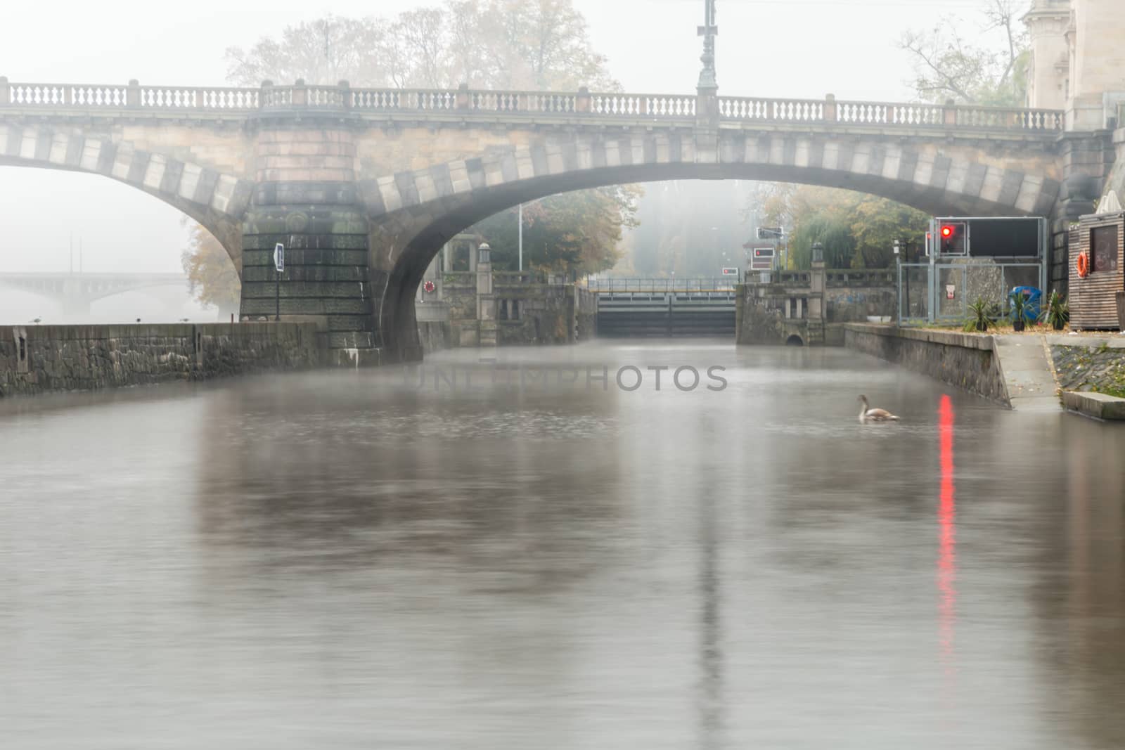 Autumn dawn in historic Prague at Charles Bridge over the Vltava River. Prague, ENESCO monument, Czech Republic