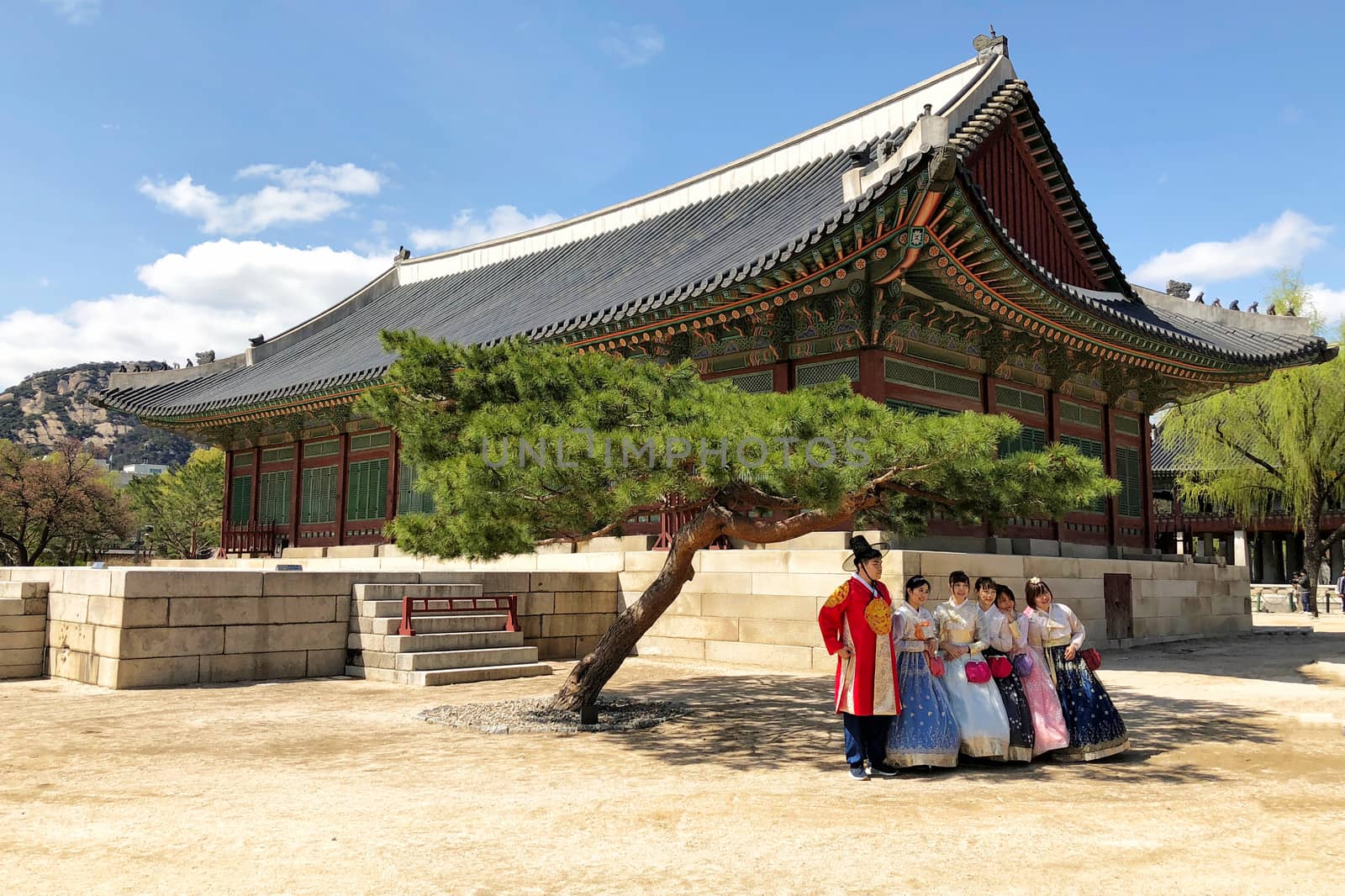 28 MARCH : A group of tourist wearing traditional korean clothing, hanbok, and taking group photo at Gyeongbokgung Palace at 28 March 2018