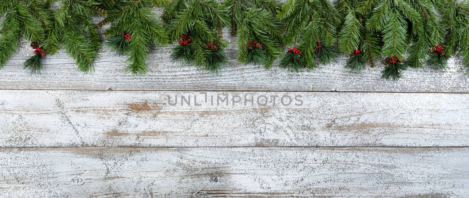 Merry Christmas or Happy New Year holiday background with red berries and evergreen branches 