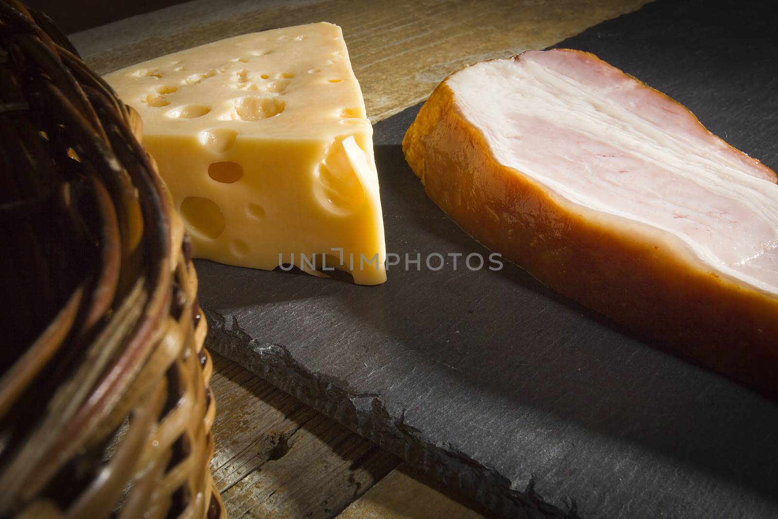 Cheese and bacon on a cutting stone board