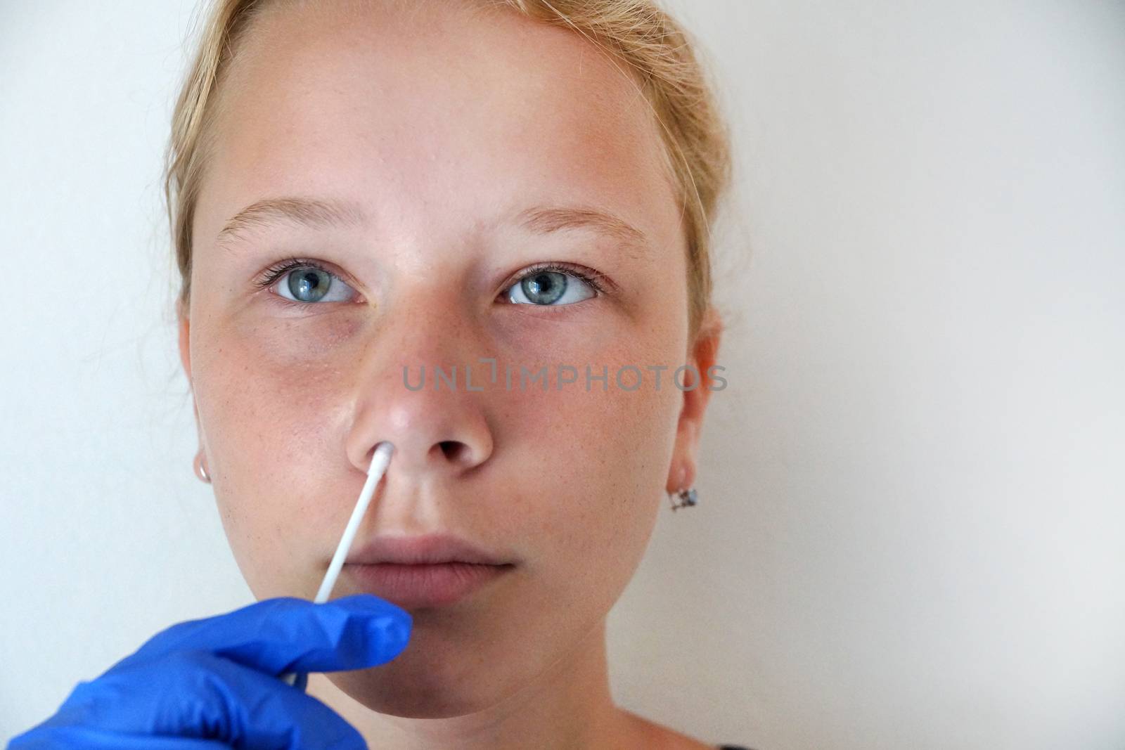 teenage girl undergoing a PCR test for coronavirus, DNA test by Annado