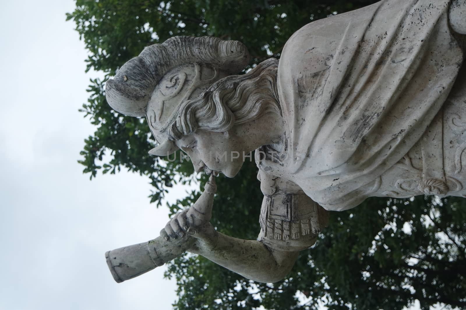 CHUNCHEON, SOUTH KOREA- October-03, 2020: sculpture of classical water god blowing conch shell - ancient natural trumpet. Stone sculpture of a Triton, blowing on his conch shell trumpet.