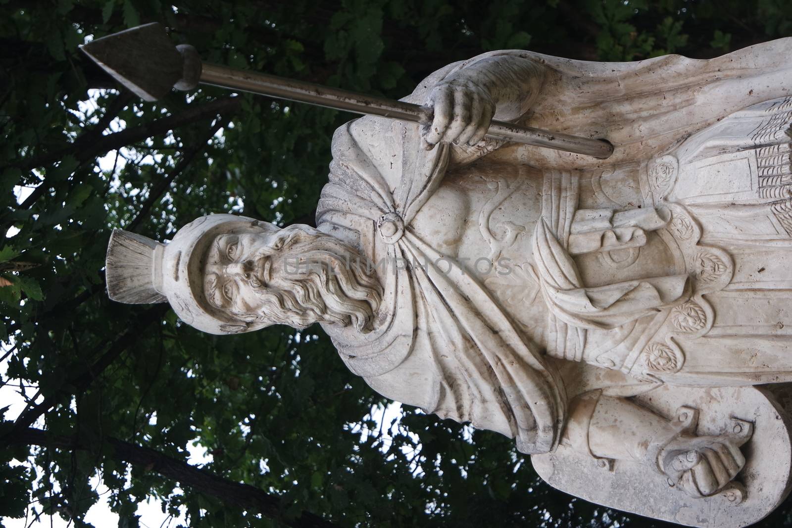 CHUNCHEON, SOUTH KOREA- October-03, 2020: Sculpture of ancient man with harpoon in hand. Human body ancient male statue made of white marble placed in a public park