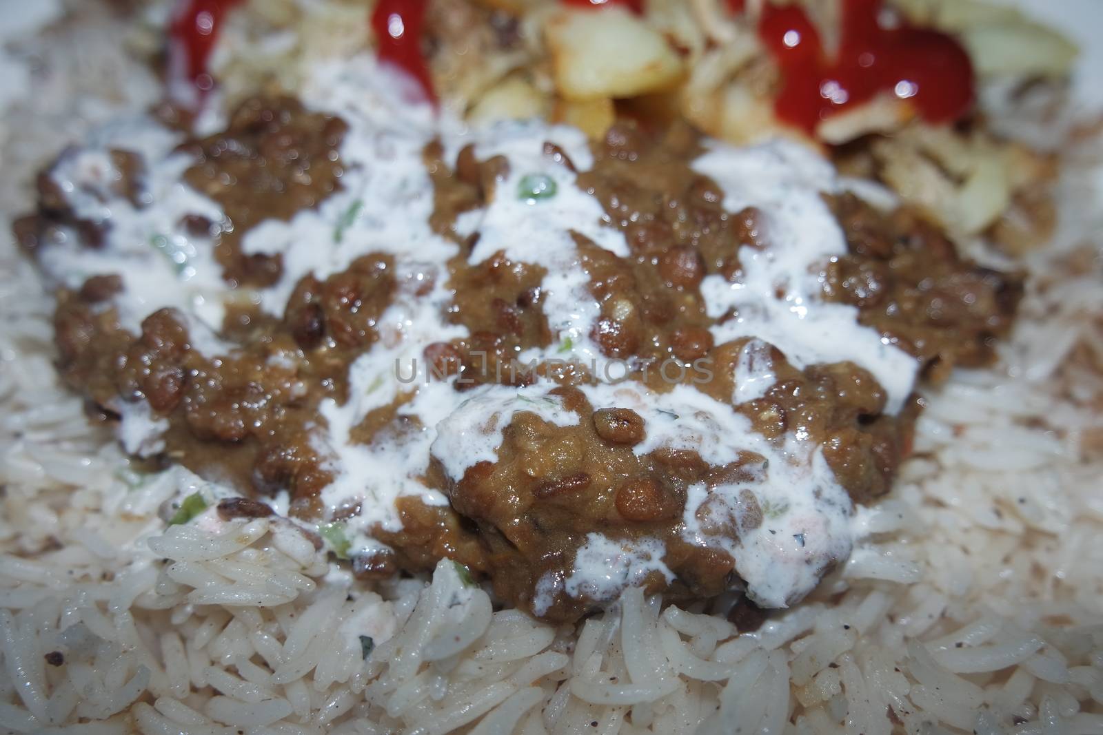 Delicious traditional dish of rice with potato fries and cereals with red ketchup. Food background with copy space for text and advertisements.