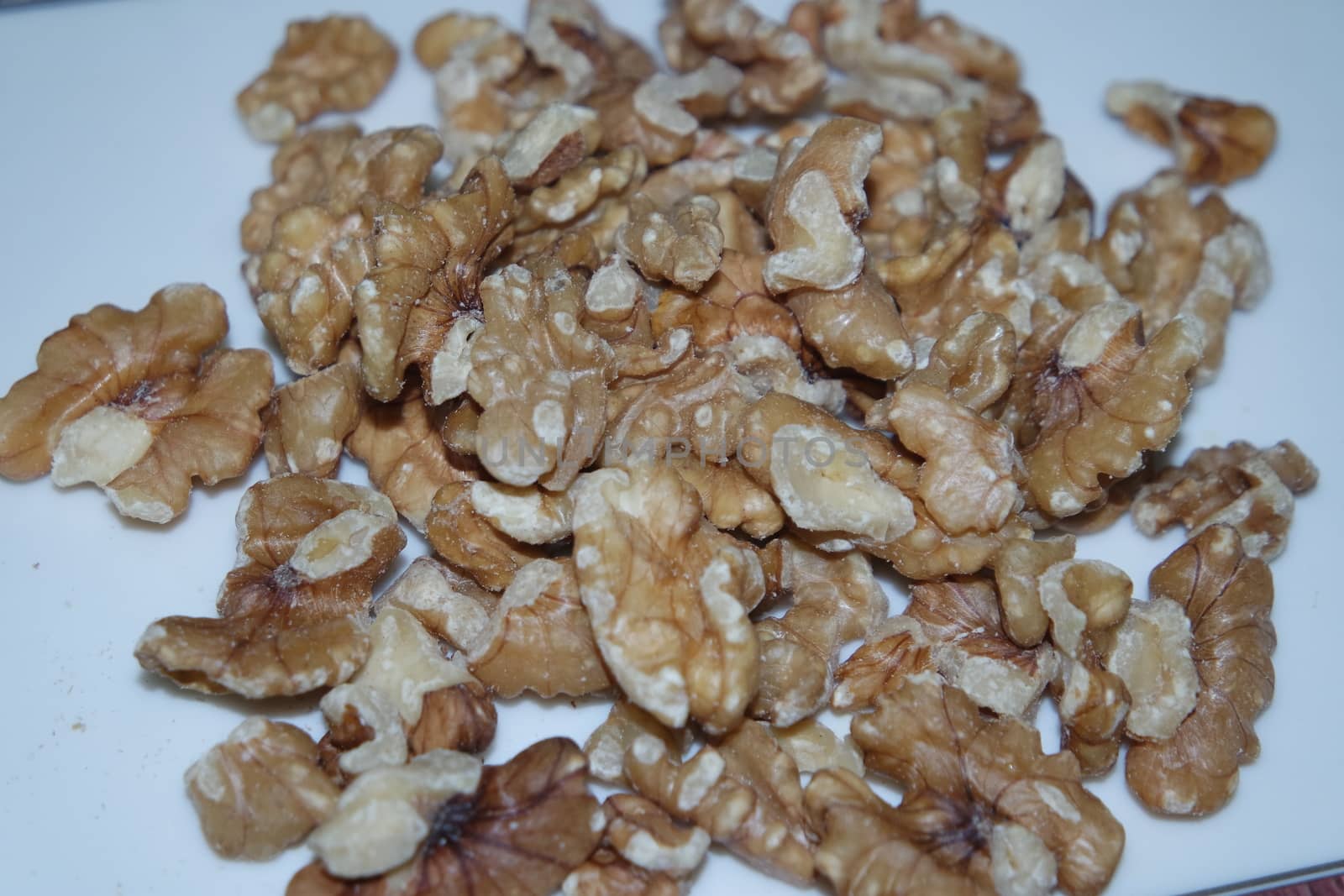 Close-up top view of peeled walnut on a white background. peeled walnut without shell ready to eat dry fruit.