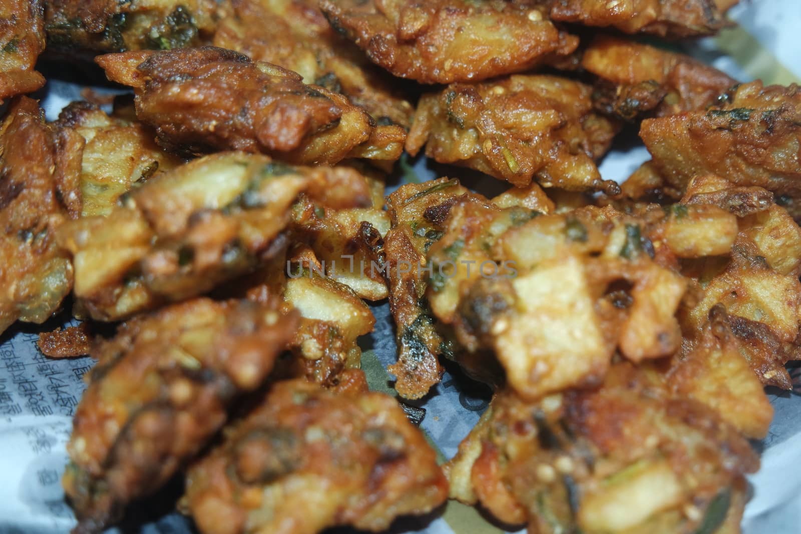 close-up view with selective focus of crispy basin pakora/pakoda or patties by Photochowk