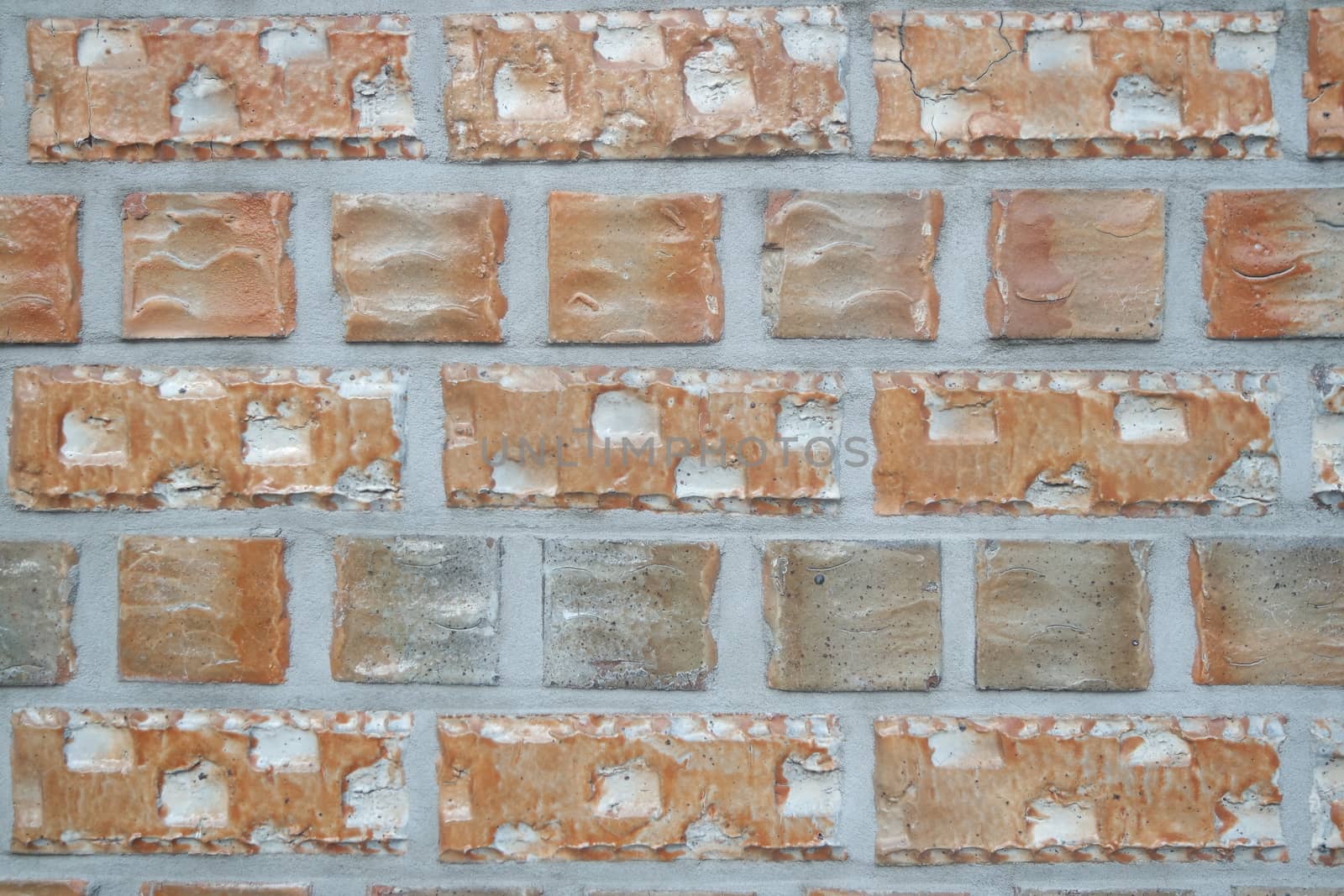 A background of a weathered old exterior brick wall in the sunshine. by Photochowk