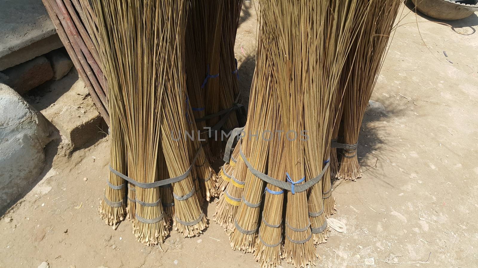 Bunch of brown colored straw broom. Old style broom used for housekeeping in rural area in Asian countries.
