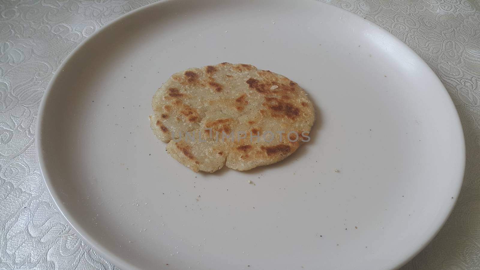 Closeup view of of traditional bread called Jawar roti or bhakri on white background. Bhakri is a round flat unleavened bread often used in the cuisine of many Asian countries