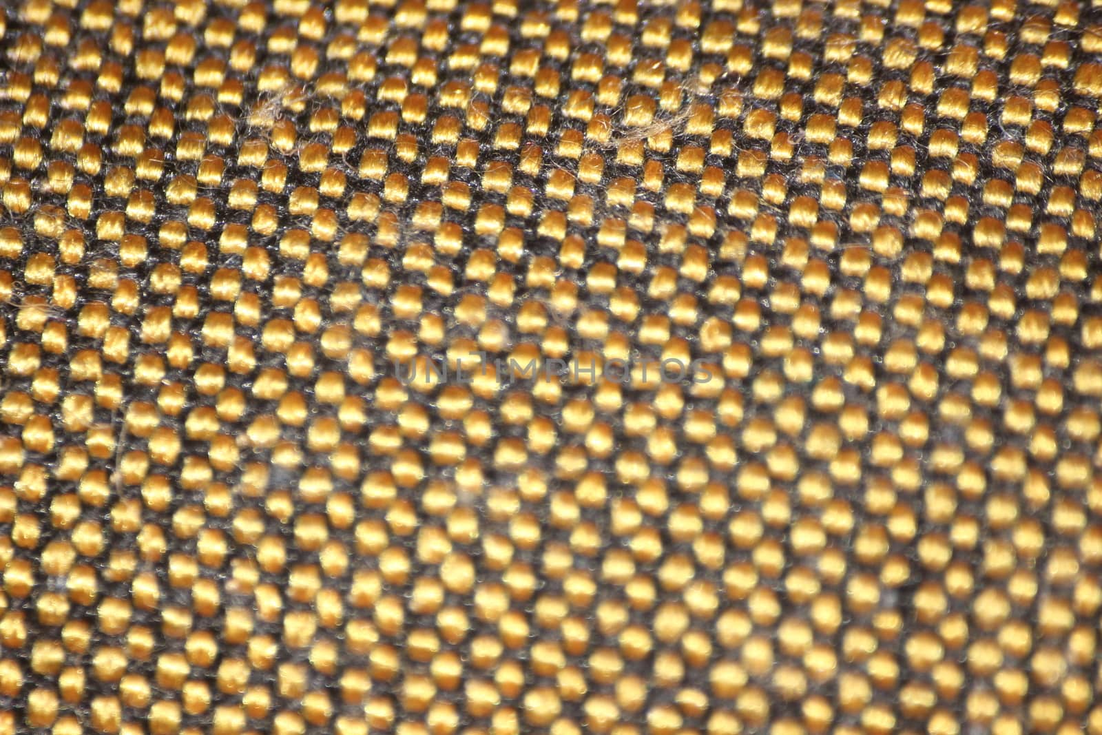 macro photo as background close up of golden color cloth fibers knitted and woven